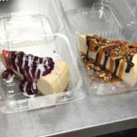 Sell Out Cheesecake · New York baked cheesecake laced with Oreo cookie crumbles topped with white and dark chocola...