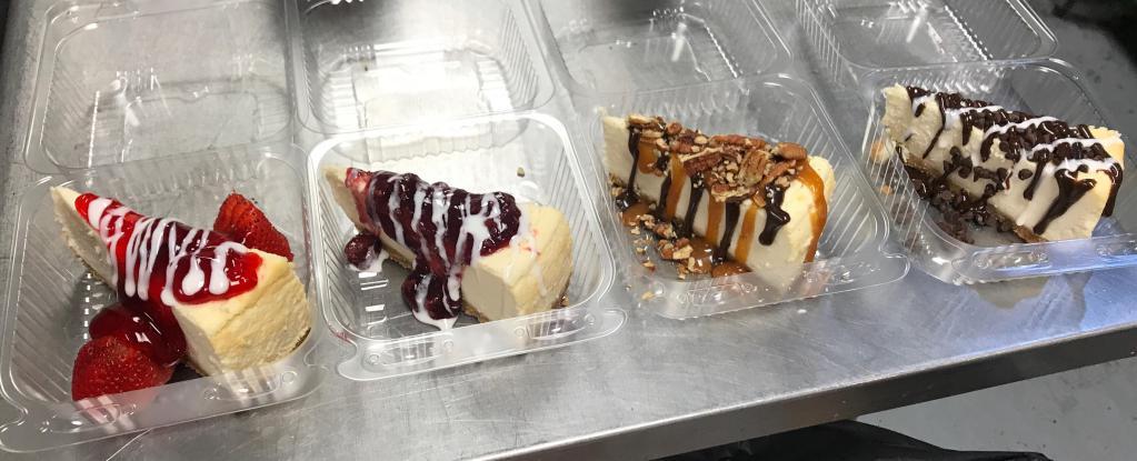 Sell Out Cheesecake · New York baked cheesecake laced with Oreo cookie crumbles topped with white and dark chocolate sauce.