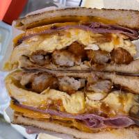 FRENCH TOSTADA · Texas French toast  based with tater tots ,scrambled eggs cheddar cheese Virginia ham 3 chee...