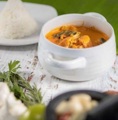 Red Curry · Red chili paste curry in coconut milk with bamboo shoots, carrots, bell peppers and fresh Thai basil.