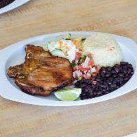 2. Chuleta de Puerco · Servido con arroz, frijoles, pico de gallo y tortilla. Pork chop. Served with rice, pico de ...
