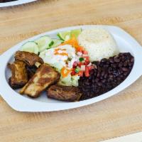 3. Costilla de Puerco · Servido con arroz, frijoles, pico de gallo y tortilla. Pork ribs. Served with rice, beans, p...