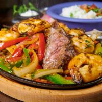 SURF CITY FAJITAS · Combo of grilled chicken, steak and shrimp sauteed onions and peppers, jasmine rice, black b...