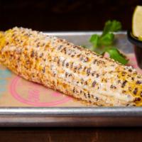 Baja Street Corn On The Cob · Char-grilled sweet corn on the cob brushed lightly with lime  mayo, chili powder, Cotija che...