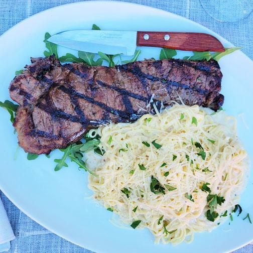 New York Steak and Linguine · Grilled, house seasoned, tender New York strip steak cooked to temperature with a  choice of fresh, handmade linguine pasta.