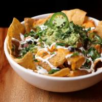 FACTORY CLASSIC NACHOS · CHEDDAR, BACON, BLACK BEANS, HOMEMADE GUACAMOLE, FRESH JALAPENOS, SOUR CREAM