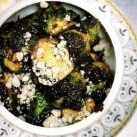 KAYCE SMITH'S BUFFALO BRUSSELS SPROUTS · ROASTED SPROUTS TOSSED IN BUFFALO SAUCE WITH BLUE CHEESE CRUMBLE