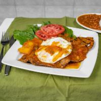 Bistec a Caballo · Steak in a crede sauce, cassava, potato, rice, beans, salad, and 2 eggs.