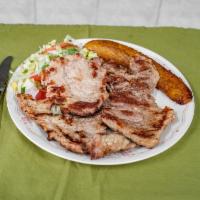Lomo de Cerdo a la Parrilla · Grilled pork loin, rice, beans, and salad.