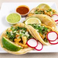 Chicken Taco (3 Pieces) · Tacos topped with fresh onions and cilantro, garnish with a lime wedge and radish, accompani...