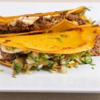 Birria Quesadilla (2 Pieces) · Two warm grilled flour tortillas filled with cheese fresh lettuce, Cotija powder cheese, and...