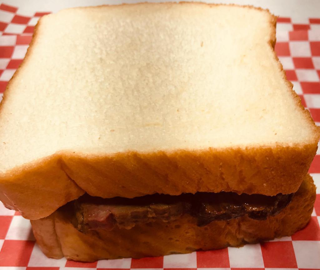 Sliced Beef Brisket Sandwich · Tender, wood-smoked beef brisket slices served with your choice of onions, pickles and our signature barbeque sauce on Texas Toast.