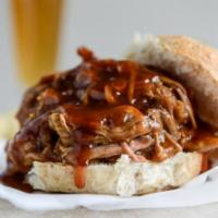 Pulled Pork Sandwich · Wood-smoked pork shoulder, chopped and served on a gourmet bun with your choice of onions, p...