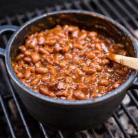Brisket Beans · Slow-cooked Pinto Beans cooked 'in-pot' with our savory wood-smoked chopped Beef Brisket.