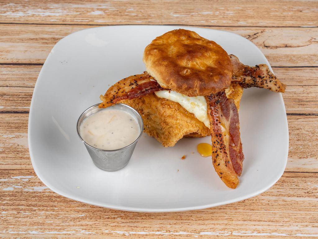 Buttermilk Biscuit & Chicken Sandwich · Crispy chicken breast nestled between warm buttermilk biscuit with honey, butter, bacon, jam peppered bacon strips and a fried egg (prepared over easy)  served with a side of country gravy.