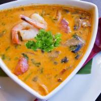Tom Kha Soup · An exotic spicy soup with coconut milk, mushrooms, tomatoes, cilantro, lemongrass, galangal ...
