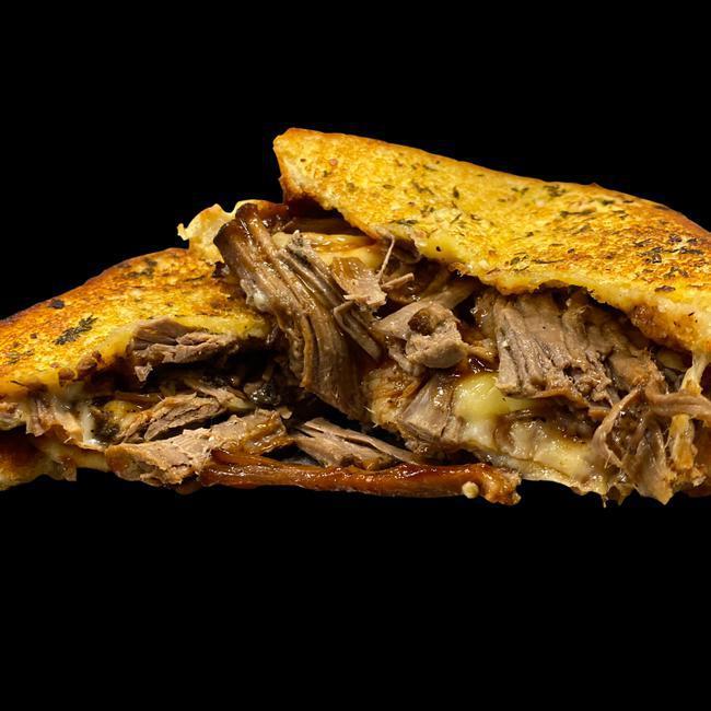 Brisket Grilled Cheese · Slow-Cooked Tender Brisket on Texas Toast Served With Monterey Jack cheese, Dressed With Stubbs BBQ Sauce