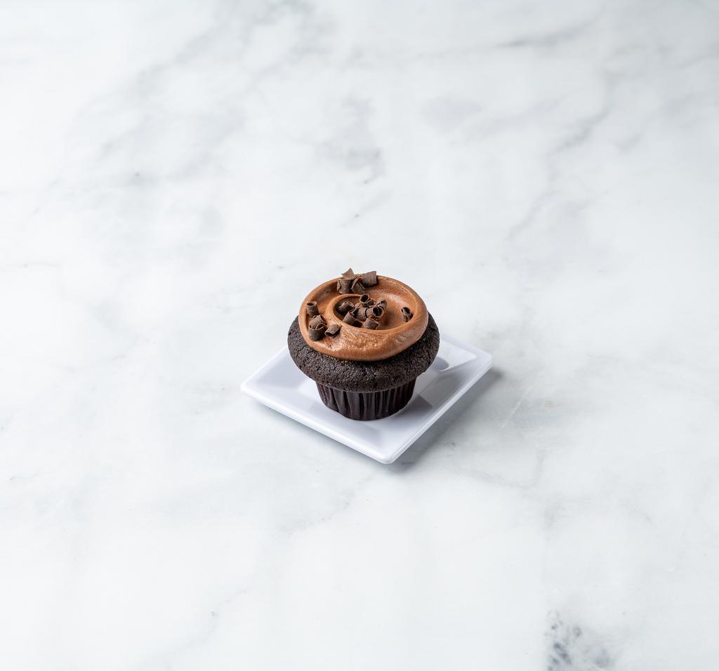 Triple Threat Cupcake · A chocolate cake frosted with chocolate buttercream and then we add dark chocolate curls. For the serious chocoholic.