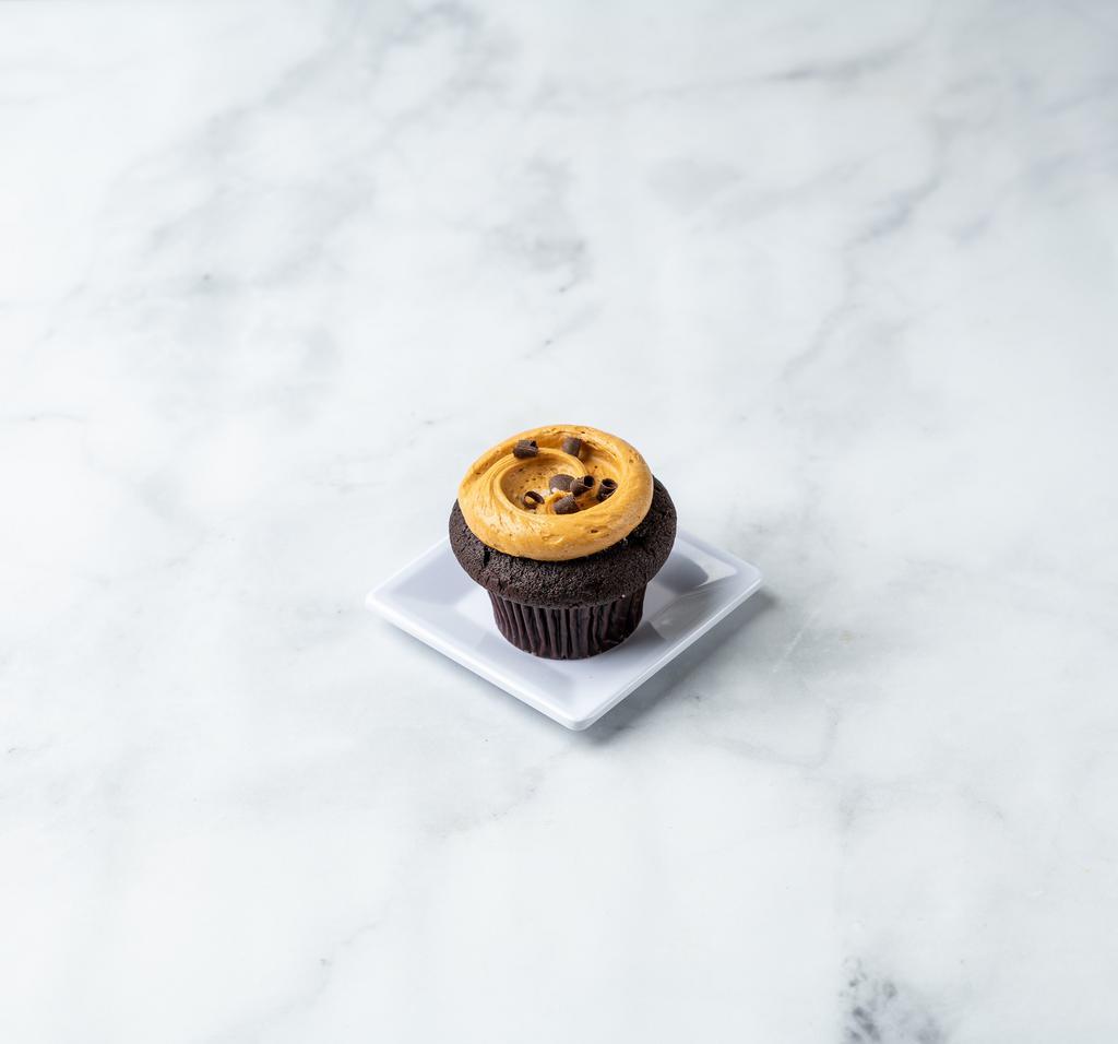 Salted Caramel Cupcake · Chocolate cake royale topped with house-made caramel buttercream, fleur de sel and dark chocolate curls.