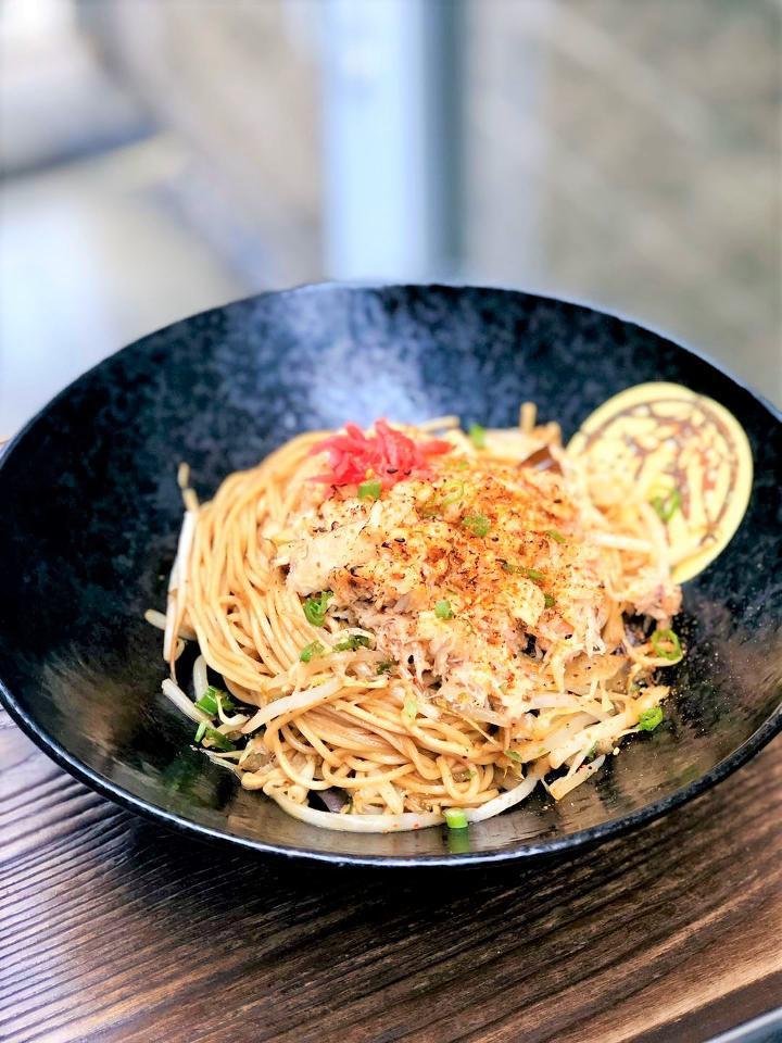 Spicy Crab Yaki Soba · Our handmade ramen noodles pan fried in organic duck oil with kikurage, scallion, cabbage, bean sprouts, fried egg and your choice of meat. All choices accompanied by a side of dashi broth with scallion and narutomaki.
 (Crab Yaki Soba does't come with fried egg. )