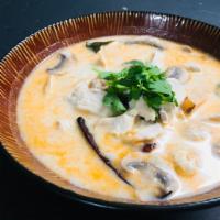 Large Tom Kha Soup · Coconut milk soup with button-mushroom, tomato, cilantro, kaffir lime leaf, lemon grass and ...