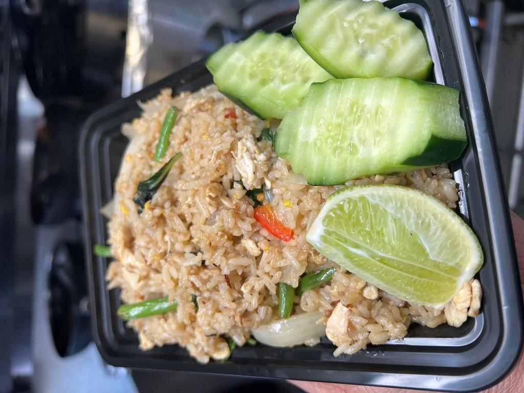 Basil fried rice · with egg, green bean, onion, red bell pepper, basil leaves topped with cucumber and lime