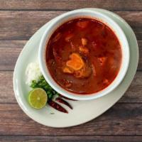Menudo · Traditional soup made with beef honeycomb tripe, simmered in a beef broth and served with on...