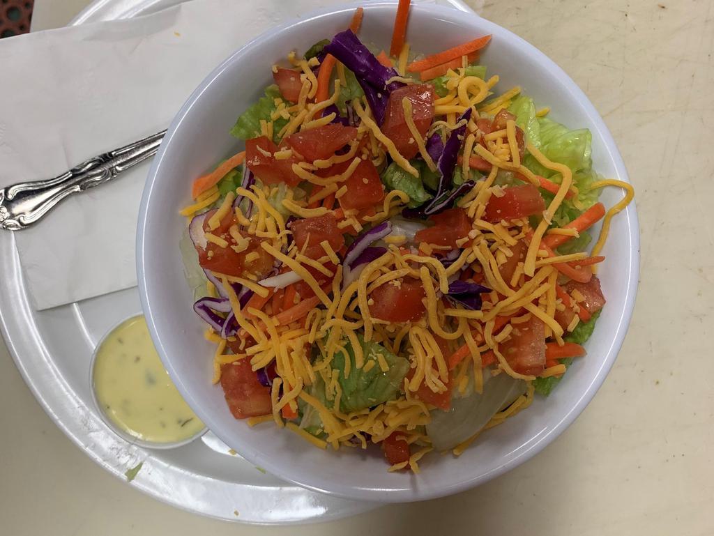 Side Salad · Iceberg lettuce, red cabbage, tomatoes, carrot slivers, and cheddar cheese.