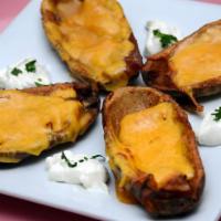 Potato Skins · Fresh, hand-scooped potato skins topped with bacon and cheddar cheese, deep fried and crispy...