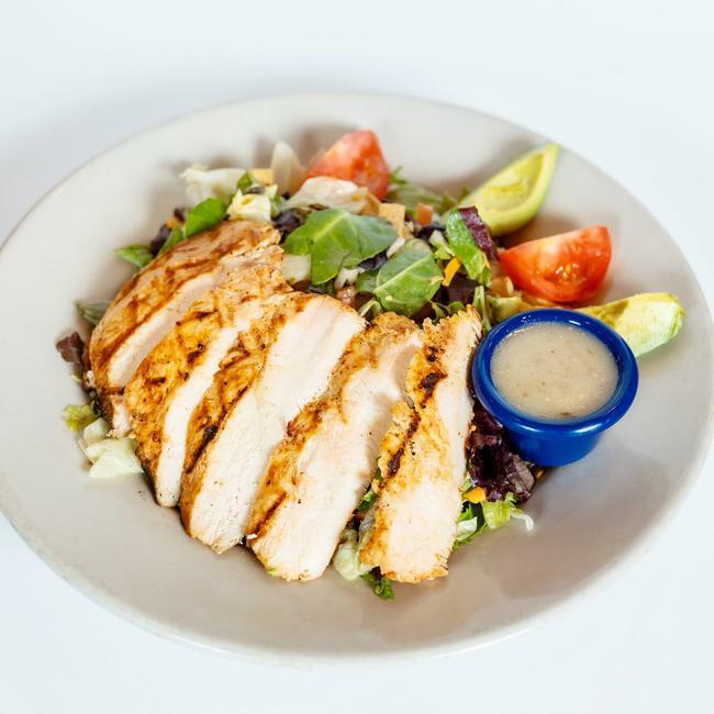 Santa Fe Salad · Marinated chicken breast, diced avocado, Monterey & cheddar cheeses, charro beans, diced tomatoes & tostada strips served on a bed of mixed greens in a tangy vinaigrette