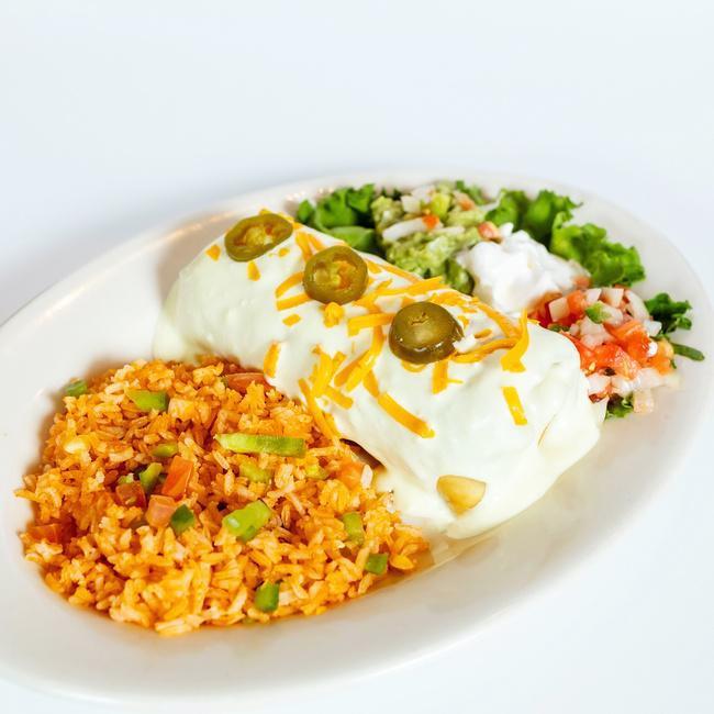Chimichanga · A deep-fried flour tortilla, filled with Picadillo beef OR seasoned chicken, covered with creamy tomatillo sauce OR chile con queso, served with sour cream, guacamole, pico de gallo & rice