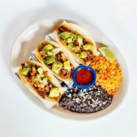 Brisket Tacos · Served in white corn tortillas with avocado, salsa &  cilantro
