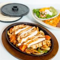 Sizzling Fajitas · With sauteed onions, bell peppers and tomatoes