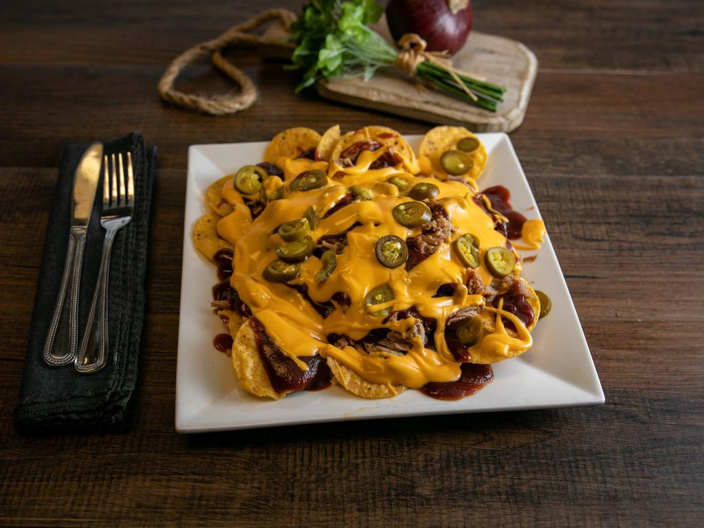 BBQ Nachos · Nacho chips topped with your choice of meat. Served with BBQ sauce, nacho cheese and jalapeno peppers on the side.