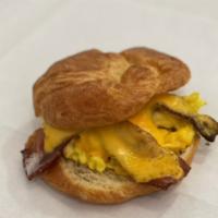 Breakfast Sandwich  · Egg scramble, choice of ham, bacon, turkey or sausage. Melted cheddar cheese served on a fre...