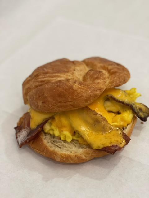Breakfast Sandwich  · Egg scramble, choice of ham, bacon, turkey or sausage. Melted cheddar cheese served on a fresh local bakery croissant.