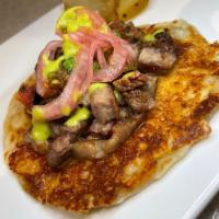Taco Miami Vice · Grilled rib eye with a cheese crisp on a flour tortilla.