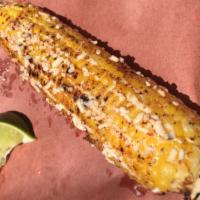 Elote · Wood fire roasted sweet corn on the cob, Mexico City style. Topped with mayo, Cotija cheese,...