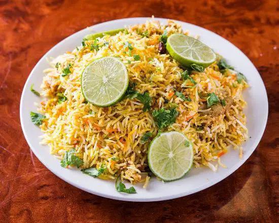 Chicken Biryani · Basmati rice cooked with chicken, spices, and special herbs.
