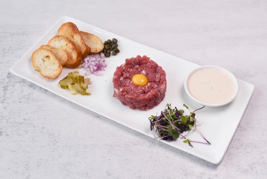 Beef Tartare Dinner · Special sauce, shallot, pickles peppers, and quail eggs.