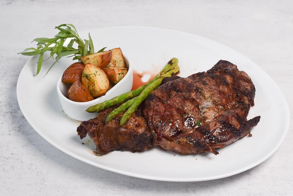 Rib Eye Dinner · Herbed prime rib-eye steak with baby potatoes and asparagus.
