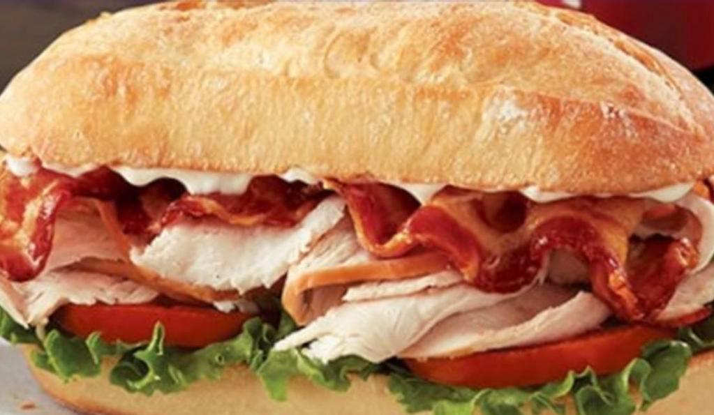 Turkey Club Sandwich · Sliced turkey with bacon, lettuce, tomato & mayo.
