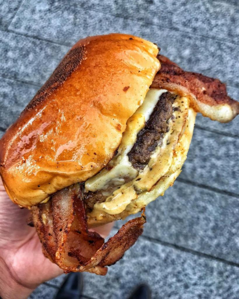 $$$ Bacon (Bacon Burger) · Daily ground Angus beef with American Cheese, applewood smoked bacon, & house sauce on a brioche bun.