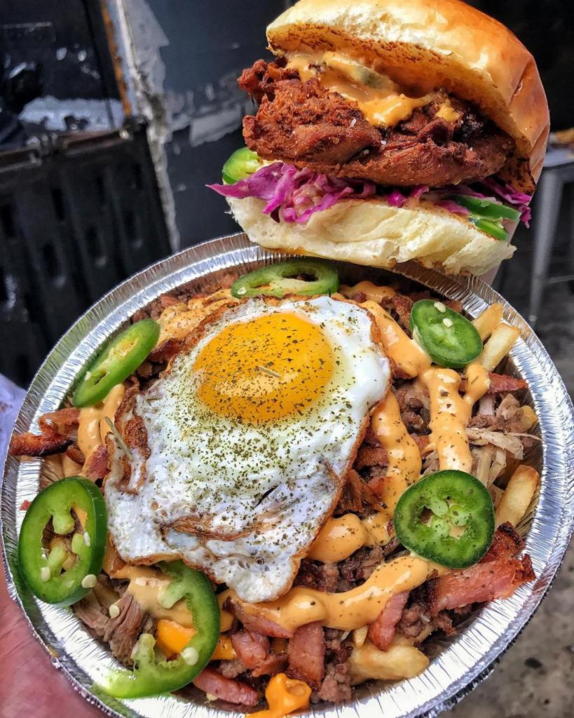 The Crew · Cheese fries served with pulled pork, jalapeno peppers, angus beef, applewood smoked bacon, fried egg, & house sauce