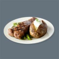 Prime Steak Dinner · Baked potato side dish.