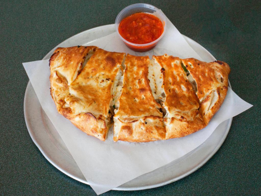 Steak Calzone · Our delicious sauce with choice sirloin steak, mushrooms, sweet peppers, onions and cheese.