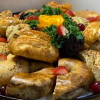 Breakfast Basket  · An assortment of freshly baked muffins, Danishes, croissant and bagels. Served with butter, ...