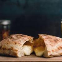 Classic Calzone · What's good. Mozzarella, ricotta, Parmesan. Served with 2 fresh tomato sauces on the side.