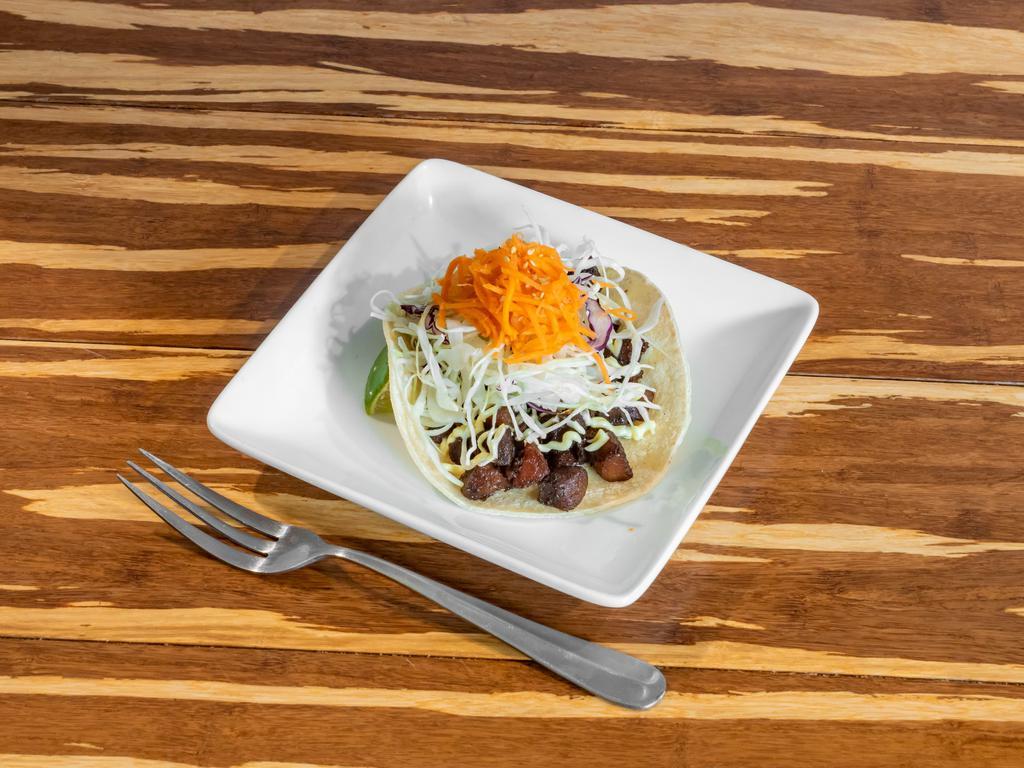 B. P. T Taco · Grilled pork, aioli and vinaigrette cabbage slaw topped with doing chua, house pickle. 