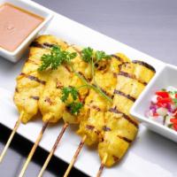 Satay Chicken · Grilled chicken skewers served with peanut dressing and cucumber salad.